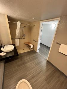 a bathroom with a toilet and a sink at Motel 6-Council Bluffs, IA - Omaha East in Council Bluffs