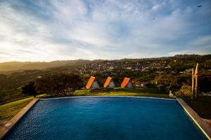 a swimming pool with a view of a city at Villa de los Vientos in Cuetzalán del Progreso