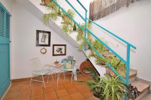 a room with a table and chairs and stairs with plants at Casa Ca Ses Nines 003 by Mallorca Charme in Muro