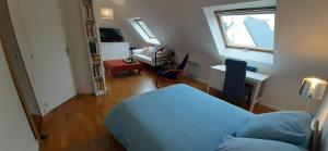 a bedroom with a bed and a desk and a window at Tous à l'ouest in Combrit