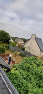 a person sitting on a bench in a garden at Tous à l'ouest in Combrit