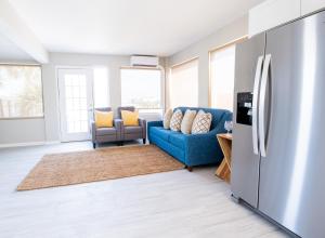 a living room with a blue couch and a refrigerator at 300 Tenth in Myrtle Beach