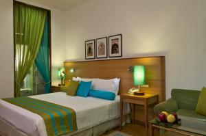 Posteľ alebo postele v izbe v ubytovaní Taj Mahal Lucknow