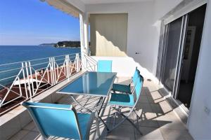 a balcony with a table and chairs and the ocean at Magic Balcony on Siviri Chalkidiki. in Siviri