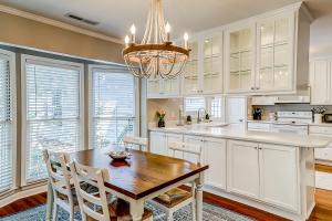a kitchen with a wooden table and a chandelier at Fox Pond Drive in Charleston