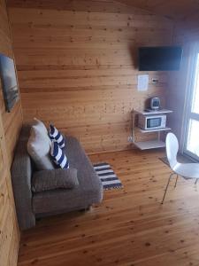 a living room with a couch and a table at Savas Uostas in Šventoji