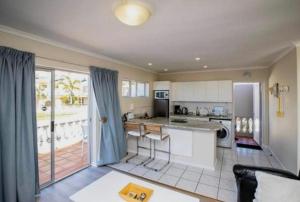 a kitchen with a table and a counter top at Secure apartment, 500m from the beach Cathcart Road, Humewood in Summerstrand