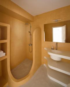 a bathroom with a sink and a shower at ASTRAVI in Kimolos