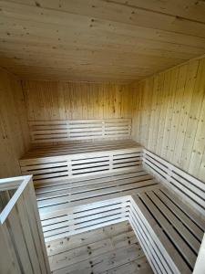 an empty sauna with wooden walls and ceilings at Morska Mila in Gąski