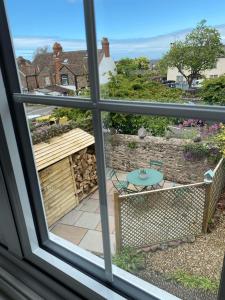 a view of a patio from a window at Little House in Porlock