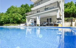 a swimming pool in front of a house at Stunning Home In Sinj With Wifi in Sinj