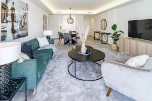 a living room with a couch and a table at INF32L- Apotel Infinity by Roomservices in Estepona