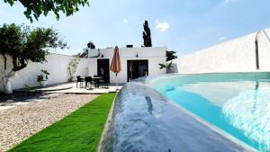 a villa with a swimming pool in front of a house at Heraklion Gortyn Phaistos House in Mitrópolis