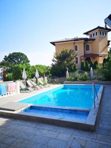 a swimming pool in front of a house at Villa Kopic in Opatija