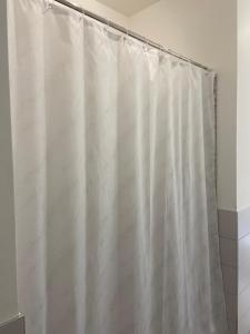 a shower curtain is hanging in a bathroom at Bari Lory’s Home in Bari