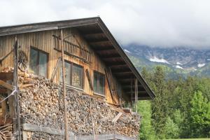 a log cabin with windows on the side of it at Oberachen Apartment in Ellmau