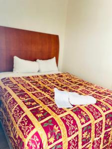 Una cama con dos toallas encima. en Miami Springs Inn en Miami