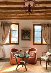 a living room with two chairs and a table at Maison Léontine in Bernay