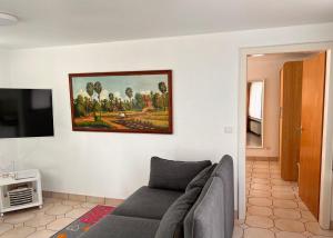 a living room with a couch and a painting on the wall at Ferienwohnung Ratana in Bad Neuenahr-Ahrweiler