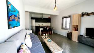a living room with a couch and a table at Heraklion Gortyn Phaistos House in Mitrópolis