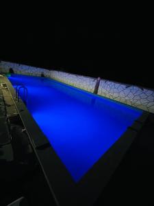 a swimming pool with blue water in the dark at Spitak tun in Ijevan