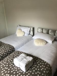 a room with three beds with white sheets and pillows at 2Bed Bungalow House, Speedwell, Bristol, UK, sleeps up to 6 guests in Bristol