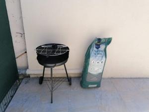 a black chair next to a wall and a bottle of water at Studio au pied du massif in Marseille