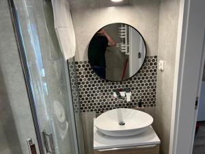 a bathroom with a sink and a mirror at Apartament Hagrid 3 - Regina Maris in Świnoujście