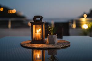 a candle and a potted plant on a table at Villa Oleander in Ulcinj