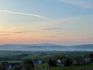 a view of the mountains from a village at sunset at Domek Panorama in Lipowa