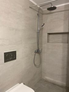 a shower stall with a toilet in a bathroom at Marina's House in Triovasálos