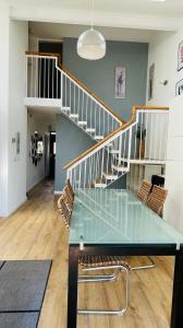 a dining room with a glass table and stairs at Modern City Centre House in Galway