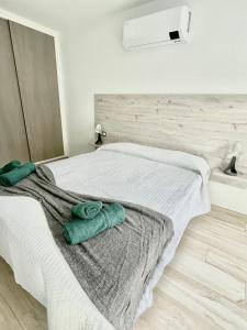 A bed or beds in a room at ISLAND SUITES