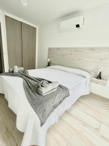 A bed or beds in a room at ISLAND SUITES