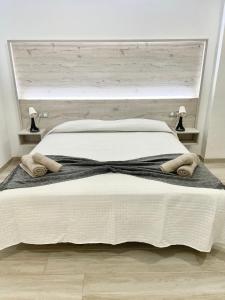 A bed or beds in a room at ISLAND SUITES