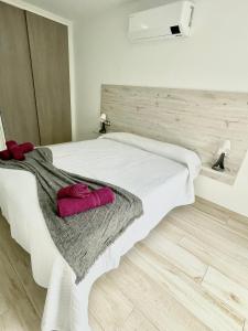 A bed or beds in a room at ISLAND SUITES