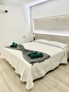 A bed or beds in a room at ISLAND SUITES