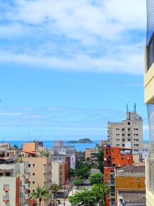 uma cidade com edifícios e o oceano no fundo em Apartamento Guarujá Enseada no Guarujá