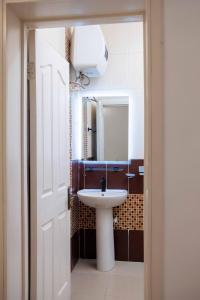 a bathroom with a sink and a mirror at Timeless Apartment Oniru in Lagos +62 photos
