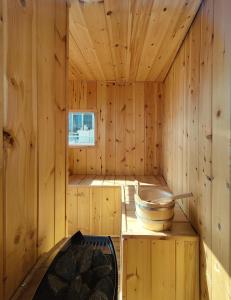 a wooden sauna with a tub and a stove at Unique solar penthouse with jacuzzi and sauna in central Athens in Athens