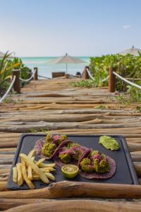 a tray of food with meat and french fries on a table at Villas Caracol in Holbox Island