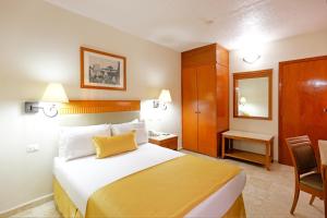 Postel nebo postele na pokoji v ubytování Hotel Olmeca Plaza
