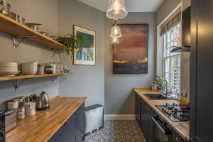 a kitchen with a counter top and a sink at Coastal Cottage: Charming three bedroom cottage with private garden in Ramsgate