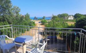 a balcony with a table and chairs and the ocean at Hotel Aia Kavatsi in Sozopol