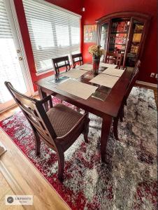 a dining room with a wooden table and chairs at 3- Bed home with Cali King Bed, 12 mins to DTWN in Atlanta
