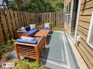 a patio with three chairs and a wooden table at 4 - Bed home with Cali King Bed, 12 mins to DTWN in Atlanta
