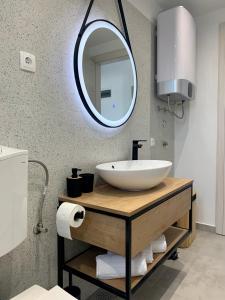 a bathroom with a sink and a mirror at Sea View Apartment - first row to the beach in Zubovići