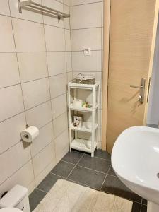 a small bathroom with a sink and a toilet at Lovely apartment by the sea 2 ….. in Epanomi