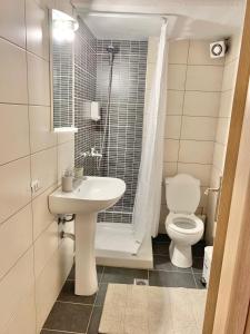 a bathroom with a sink and a toilet at Lovely apartment by the sea 2 ….. in Epanomi