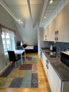 a large kitchen with a table and a couch at Novatind - Studio apartment with free parking in Narvik
